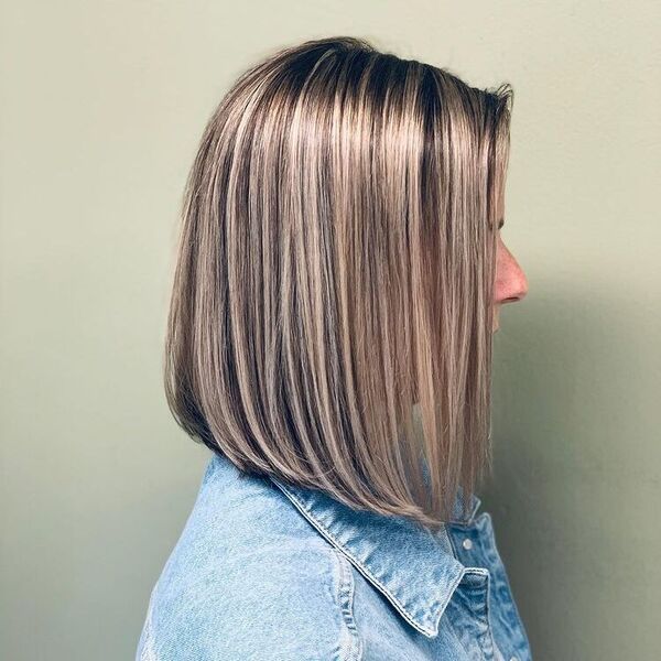 Cream Blonde Long Bob - a woman wearing denim jacket