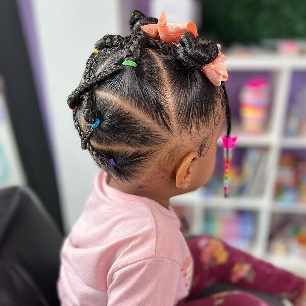 Criss Cross Braids with Small Bun - a girl is wearing pink shirt