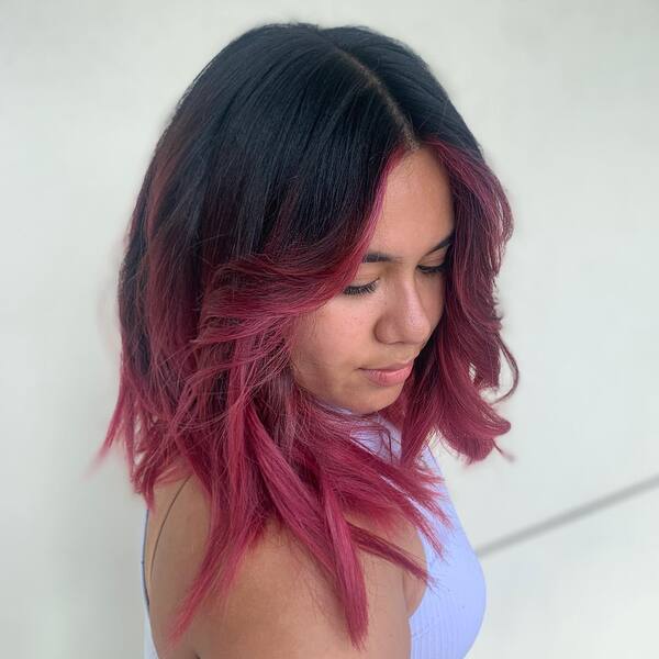 A woman wearing lavender tank top