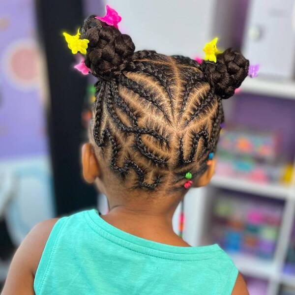 Delicate Braids in Two Braided Buns - a girl is wearing blue sleeveless top