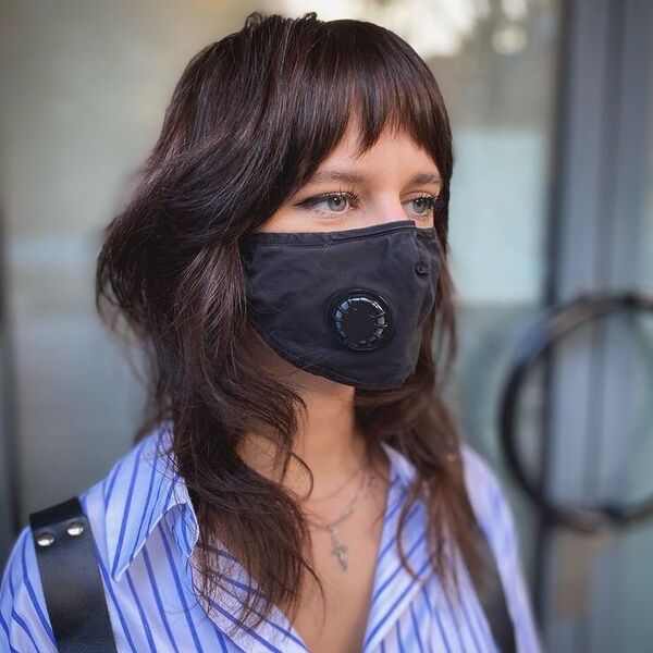 Feather Hair with Shag Fringe - a woman wearing black mask in polo