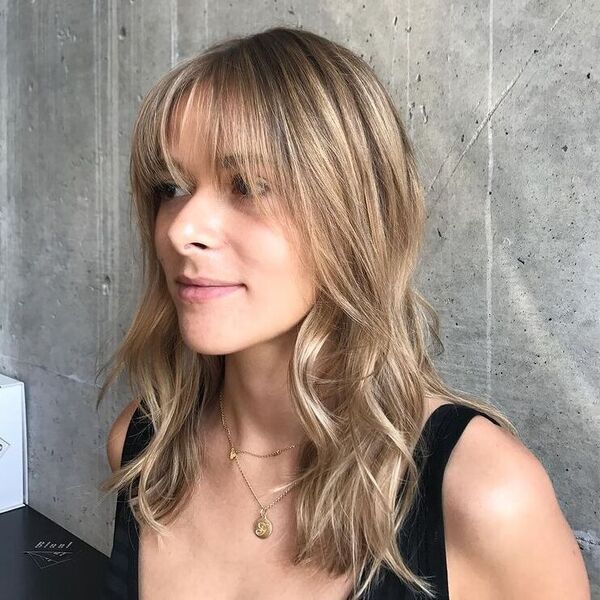 Fine Shaggy Fringe - a woman wearing black tank top