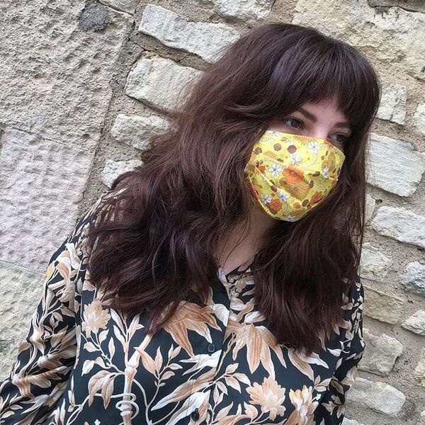 Full Curtain Fringe on Medium Hair - a woman wearing floral long sleeves