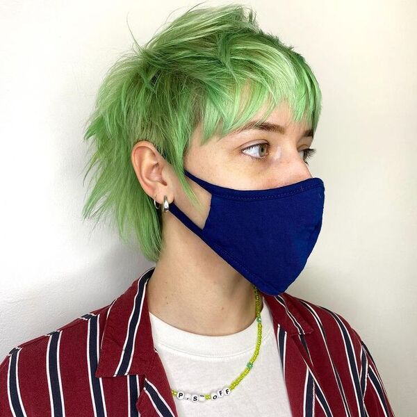 Green Pixie Fringes - a woman wearing blue mask