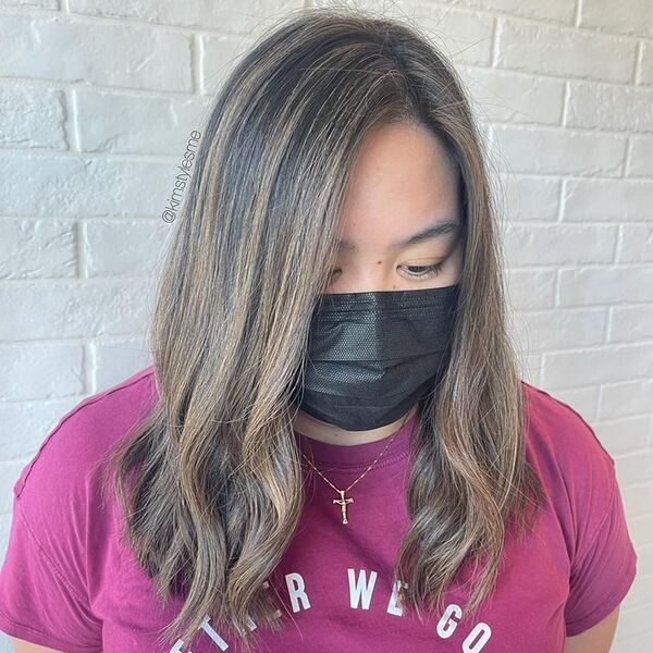 Highlighted Long Lob with Curls - a woman wearing purple top and mask