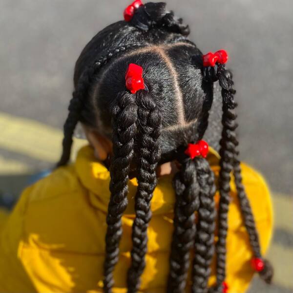 Knotted Jumbo Braids - a girl wearing yellow jacket