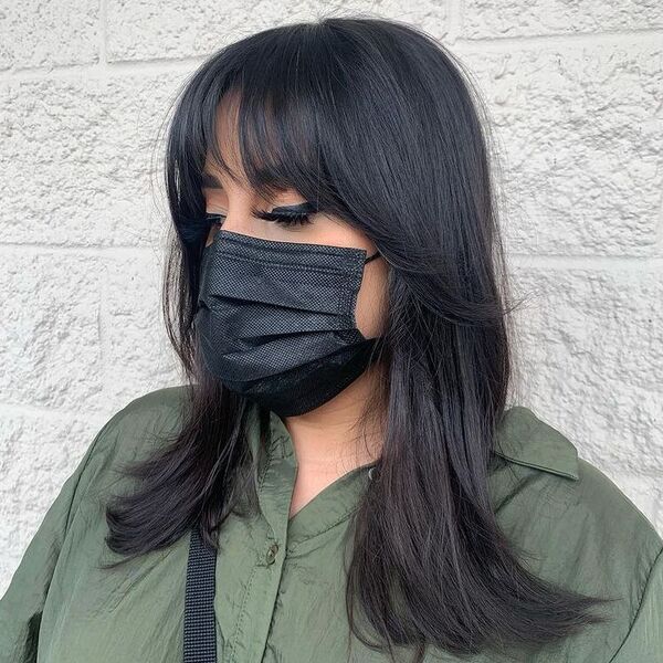 Layered Fringe Black Hair - a woman wearing black mask in green polo