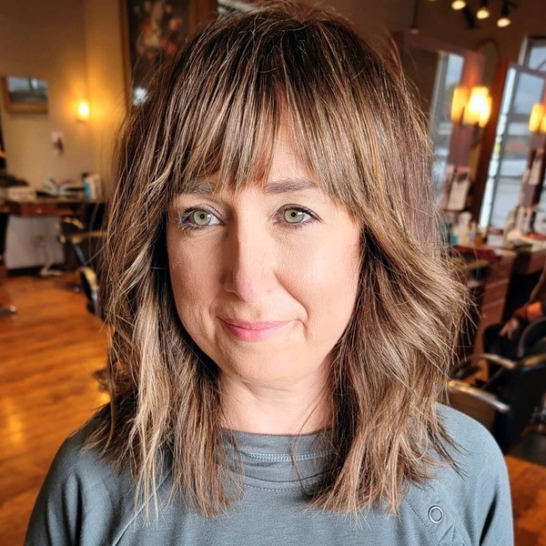 Long Bob Shag Fringe - a woman wearing gray shirt