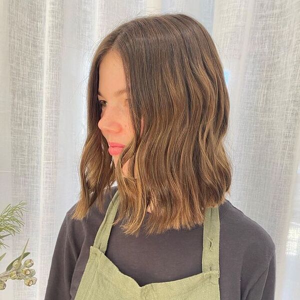 Long Bob Soft Waves - a woman wearing black sweater