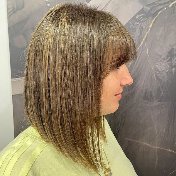 Long Bob with Blunt Bangs - a woman wearing yellow shirt