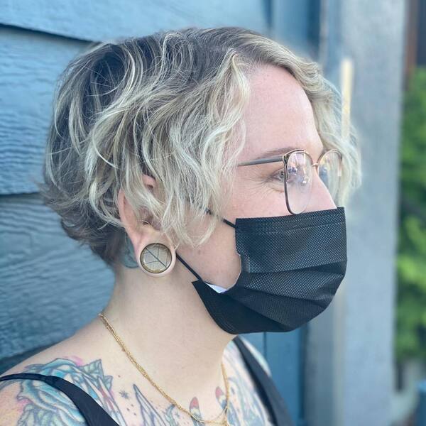 A woman wearing black mask and tank top