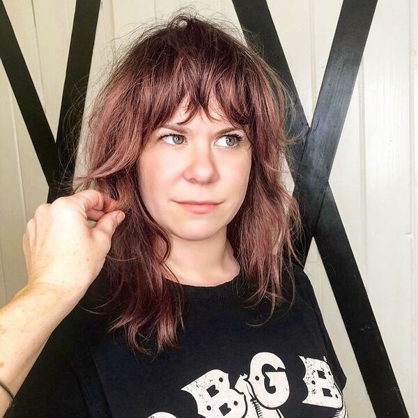 Messy Copper Hair with Fringe - a woman wearing black printed shirt