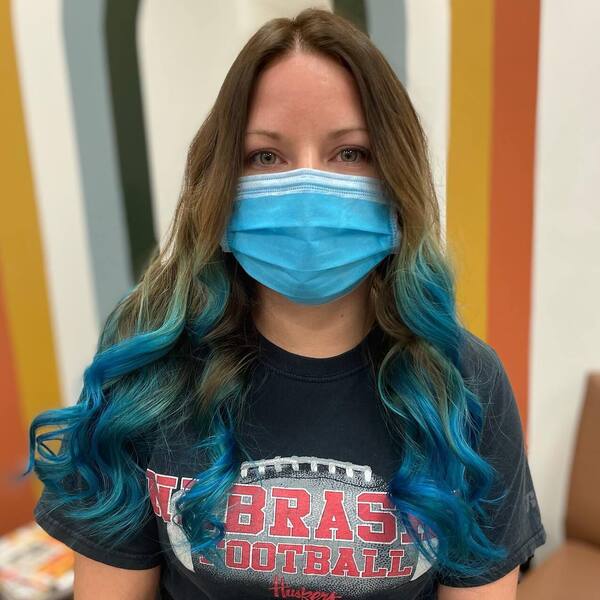 A woman wearing blue mask in black shirt