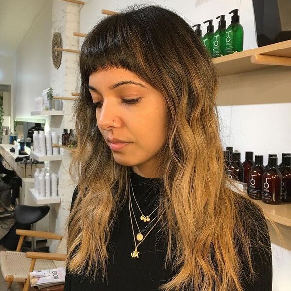 Mid Length Fringe Wavy Hair - a woman wearing black sweater with necklaces