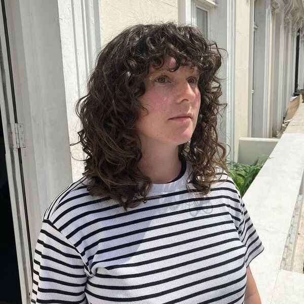 Natural Curls Shag Fringe - a woman wearing white stripe top