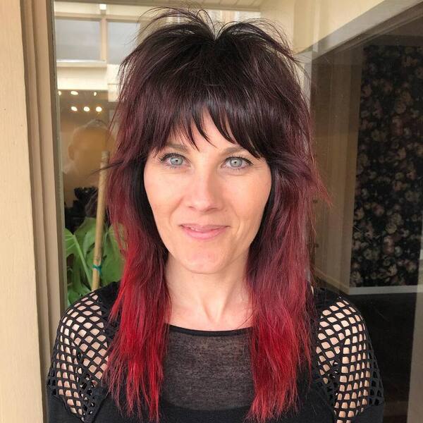 Retro Shaggy Fringe Mullet - a woman wearing punky black top