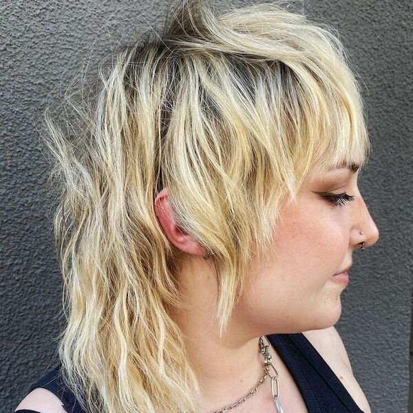 Rooty Blonde Mullet with Bangs - a woman wearing black tank top