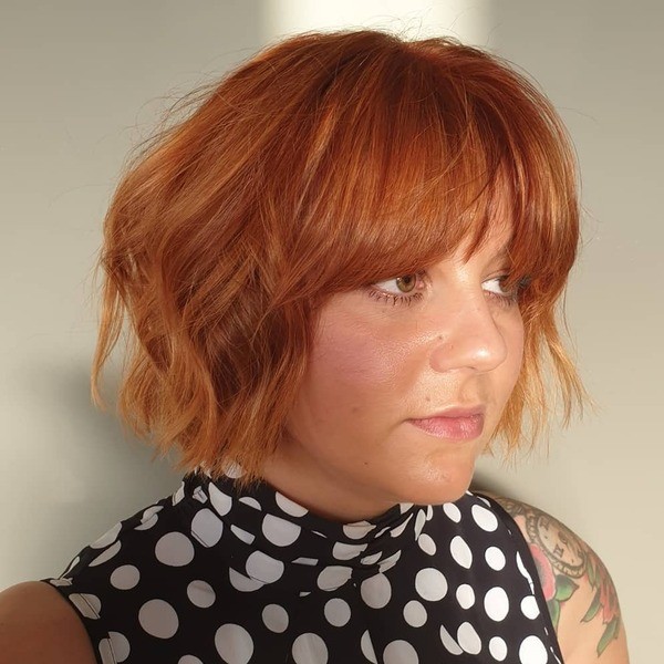 Styled Short Copper Fringe - a woman wearing polka turtle neck