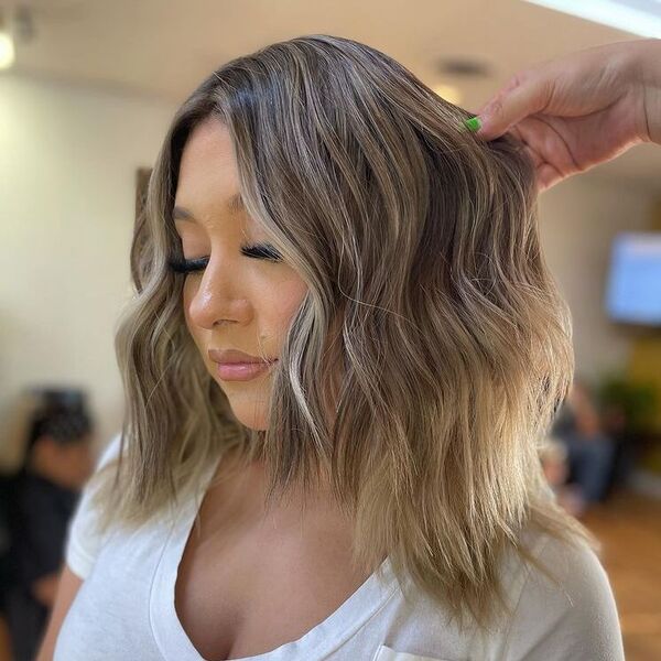 A woman wearing white V neck top