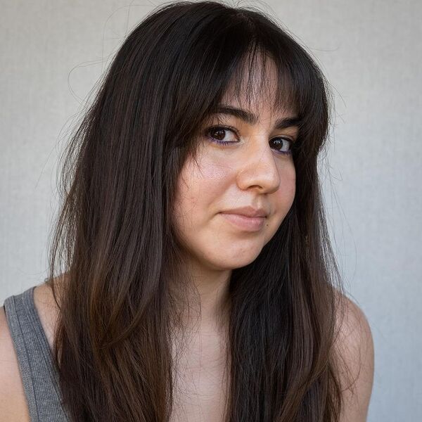 A woman wearing gray tank top